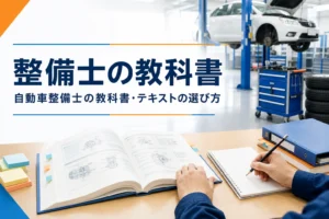 自動車整備士の教科書・テキストの選び方を紹介する記事のアイキャッチ。開いた教科書とノートが置かれた整備工場の机